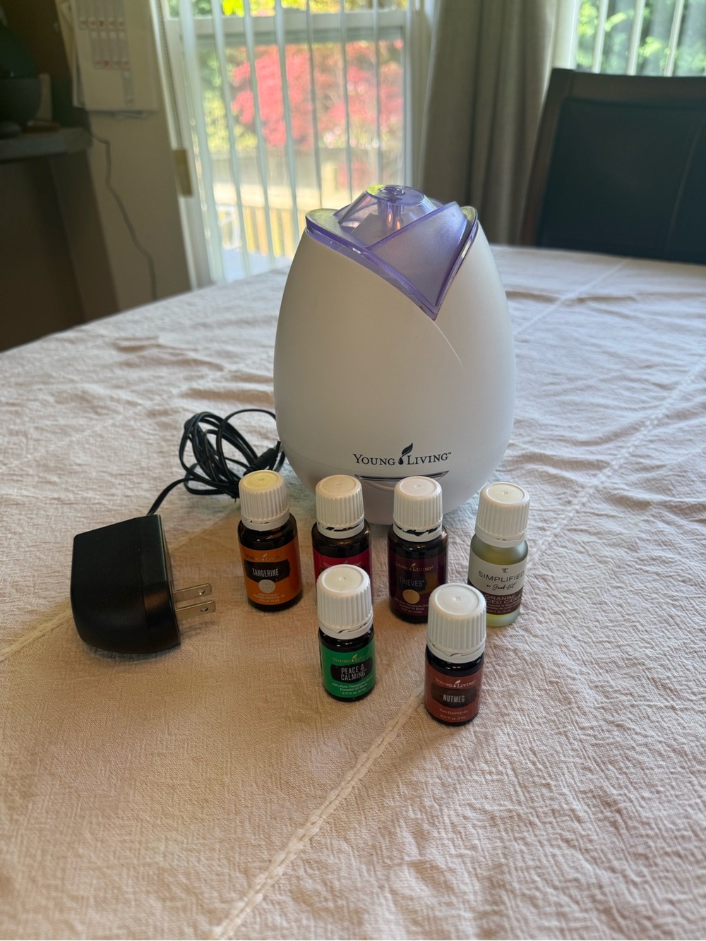 Young Living Diffuser with Lavender-Toned Top and Essential Oils